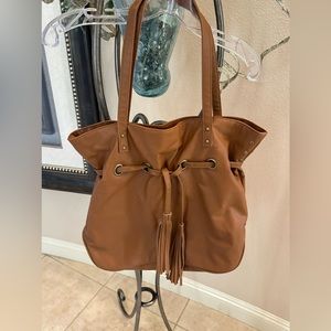 Woman’s tan faux leather shoulder purse